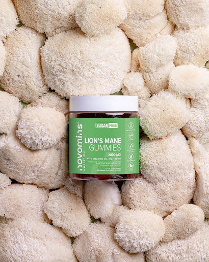 A pile of lion's mane mushrooms with a bottle of Novomins Lions Mane is the middle